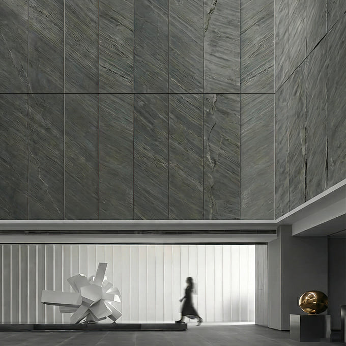 Mantra grey slate stone veneer cladding on a tall facade feature wall.
