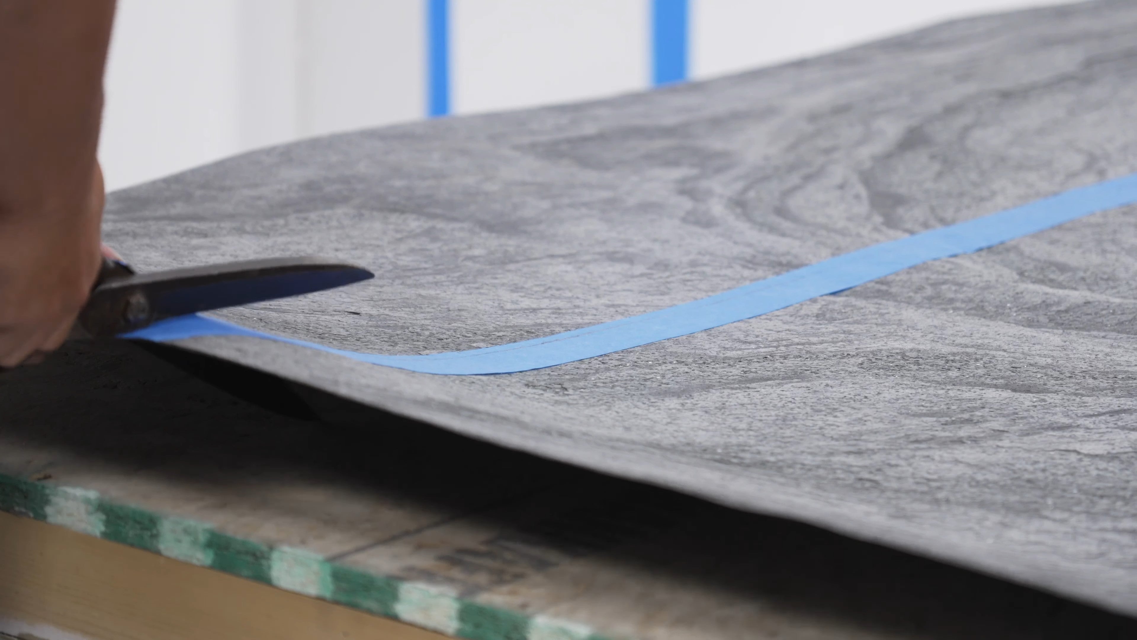 Close view of Stonovia flexible stone veneer being cut with scissors